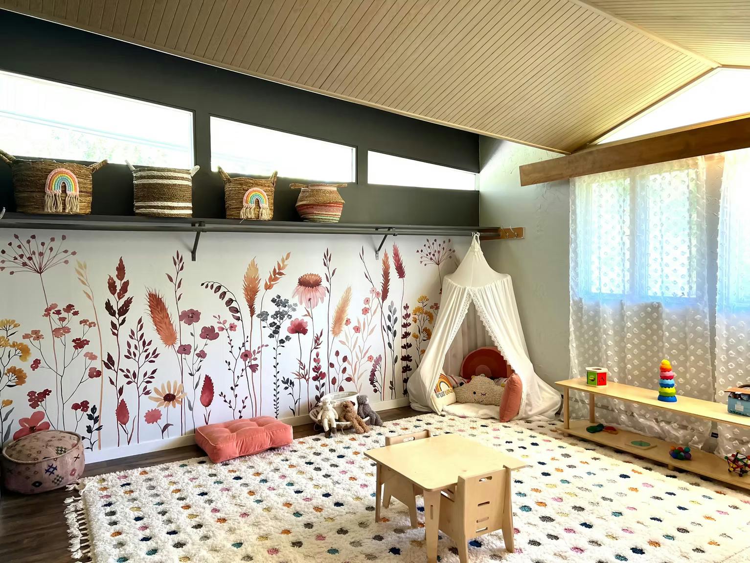 Playroom with a wildflower mural, a canopy play tent, and children's furniture