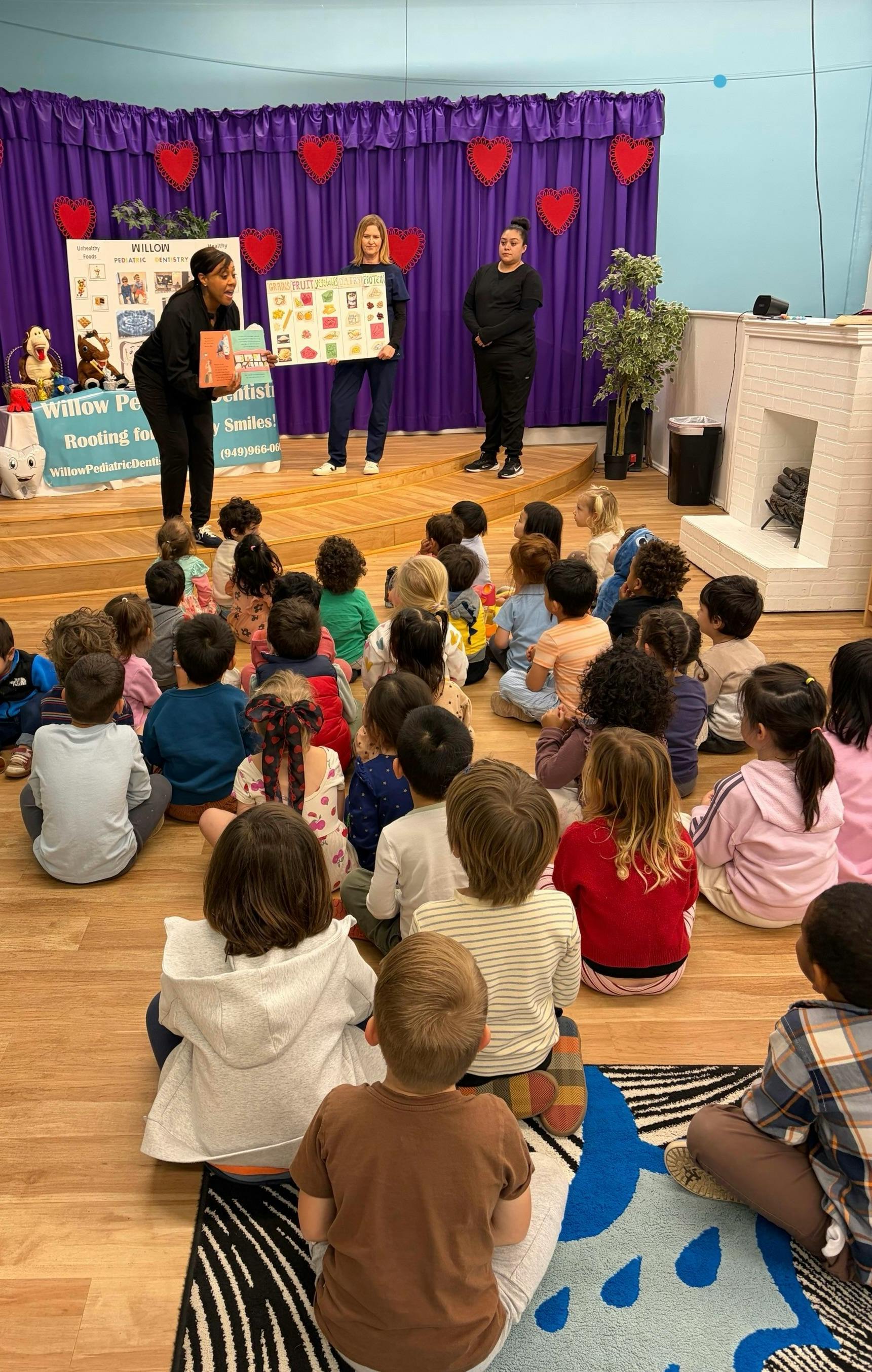 Adults presenting to a group of children seated on the floor
