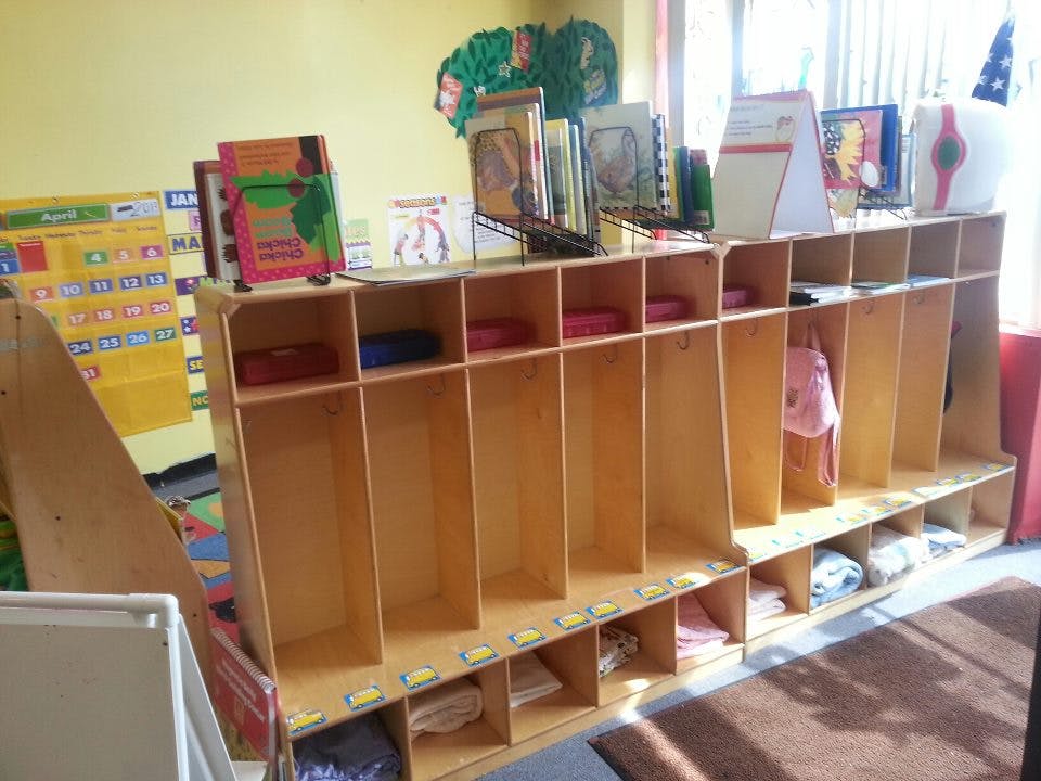 Wooden cubbies with books on top shelves in a classroom