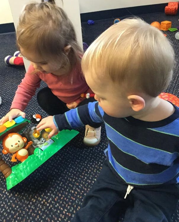 Two children playing with a toy