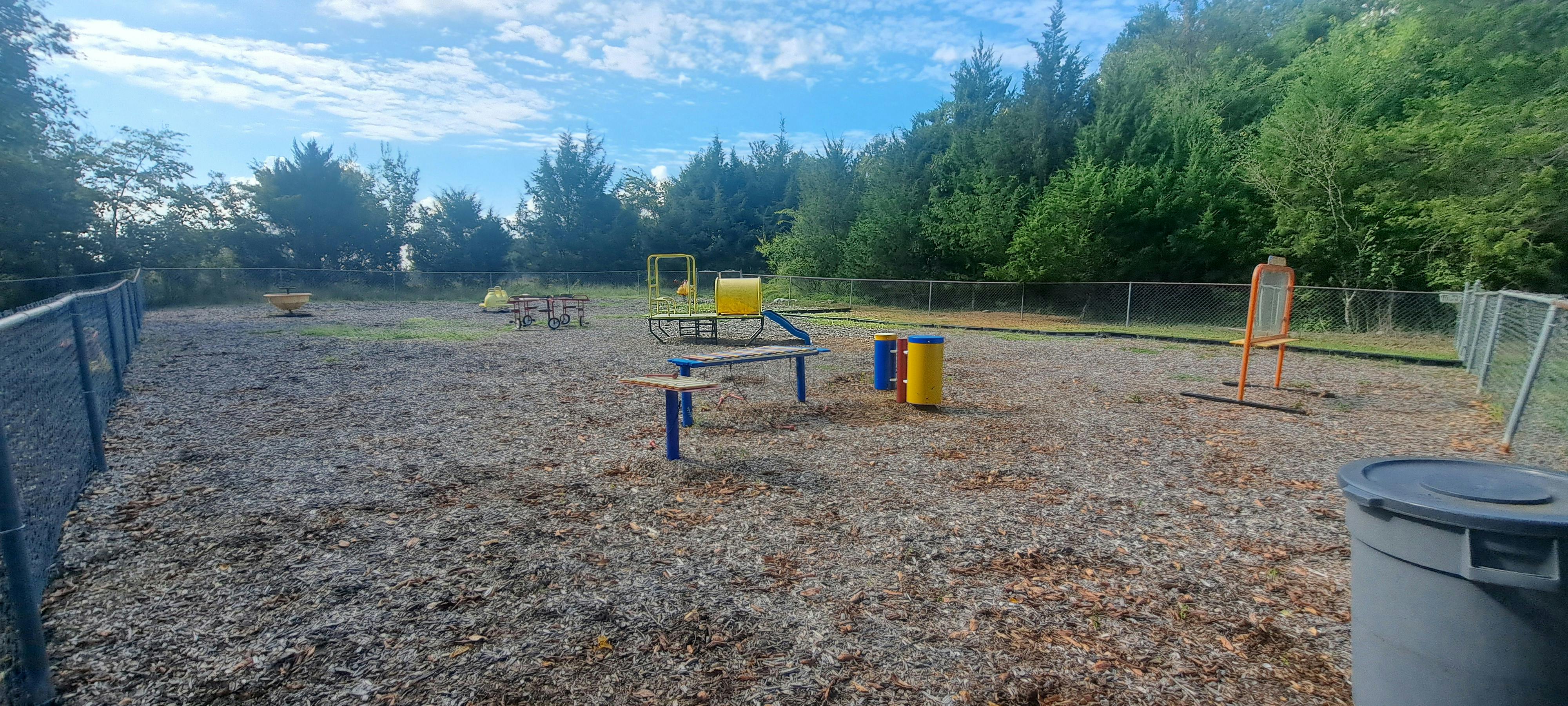 Outdoor dog park with agility equipment and play equipment