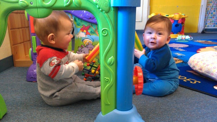 Two children playing with toys on the floor