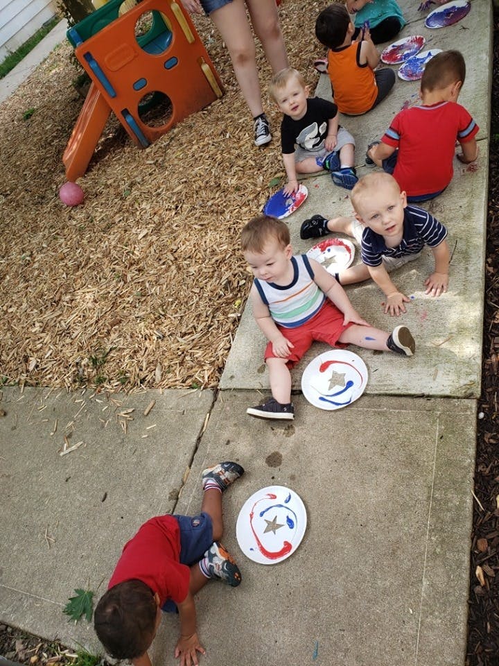Children playing with frisbees on a sidewalk