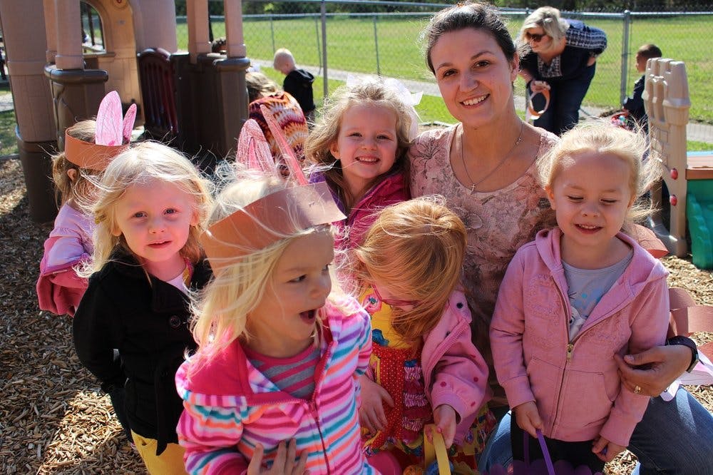 Adult and multiple children on a playground