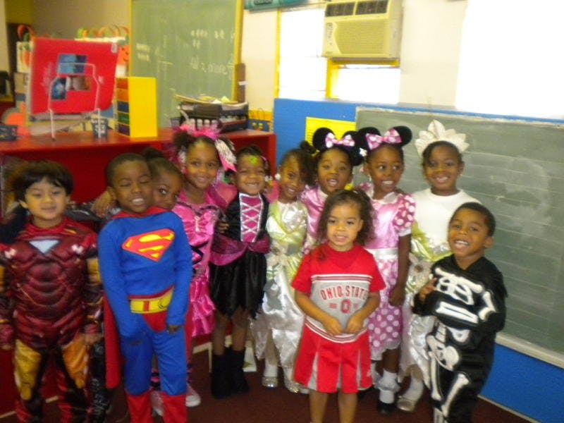 Group of children in various costumes standing together