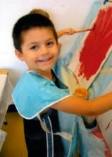 Child painting on an easel