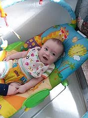 Child lying on a play mat