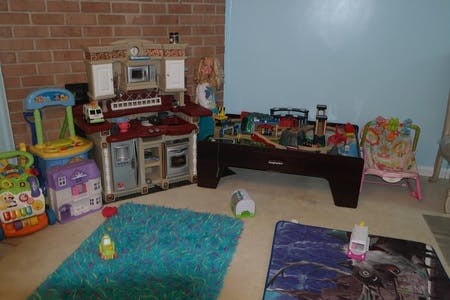 Children's play kitchen and train table in a room