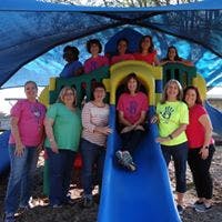 Group of people on and around a playground slide
