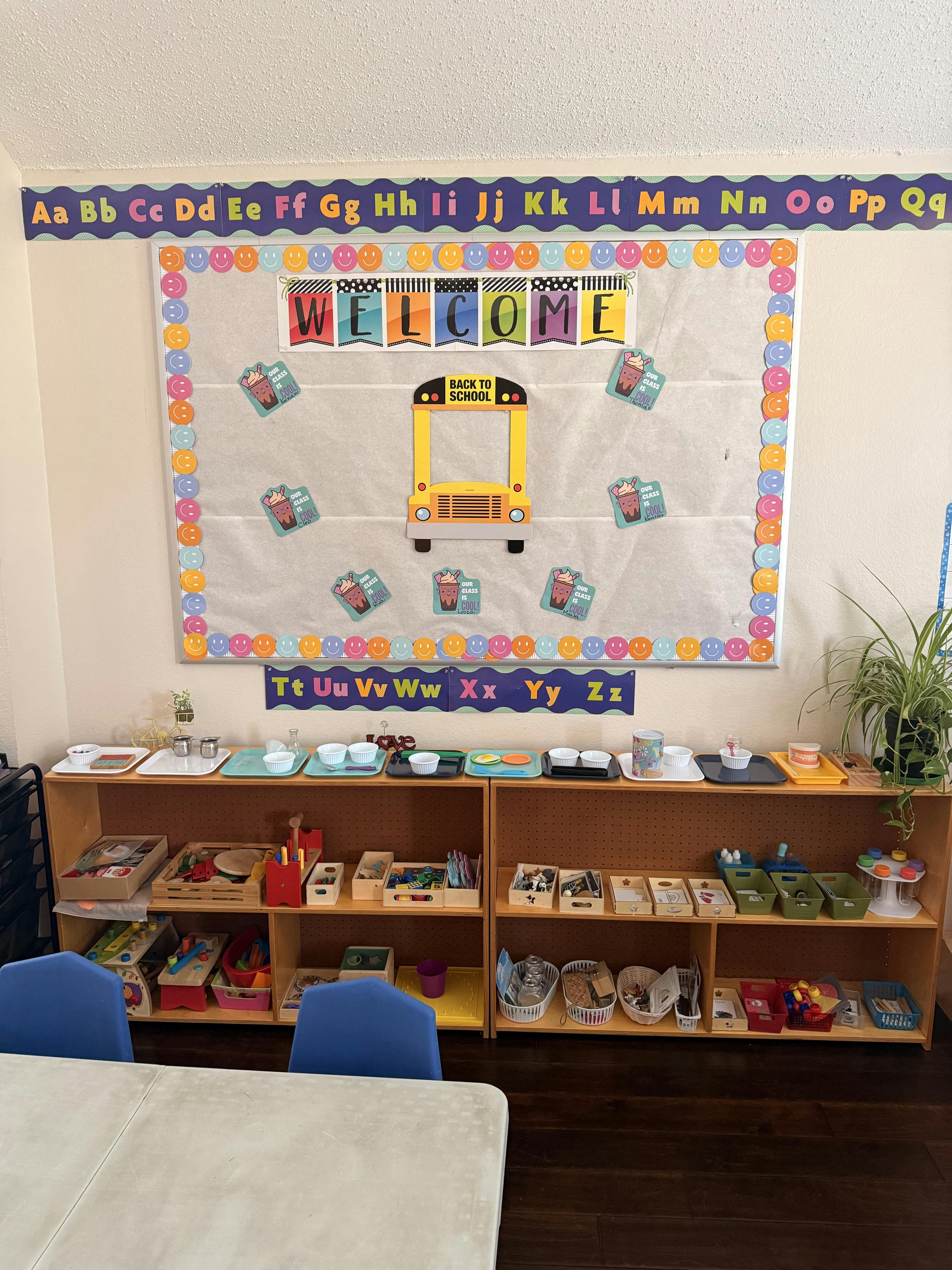 Classroom with a "Welcome" sign, alphabet border, and shelves with learning materials