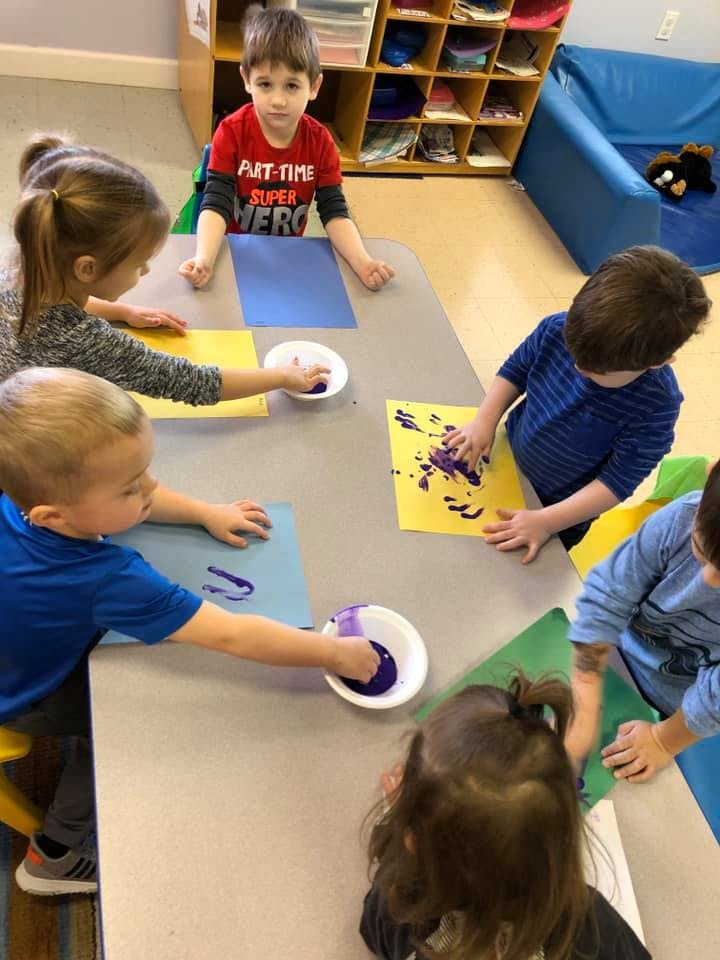 Children painting at a table