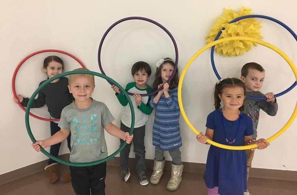 Group of children holding hula hoops