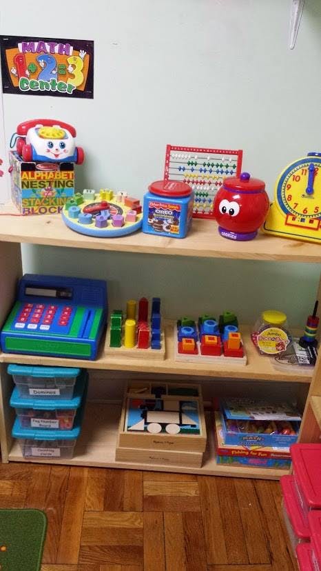 Shelves with various educational toys and a "Math Center" sign