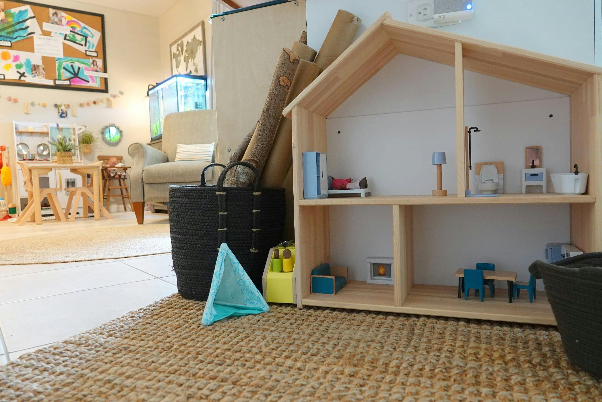 Wooden dollhouse with miniature furniture in a room