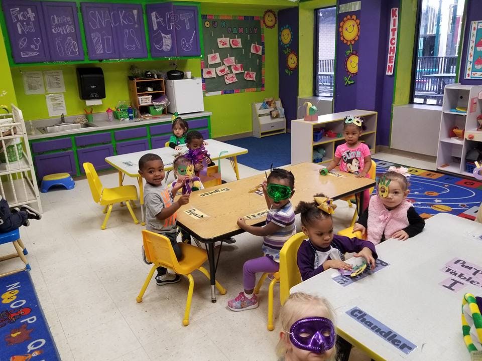 Children sitting at tables in a classroom