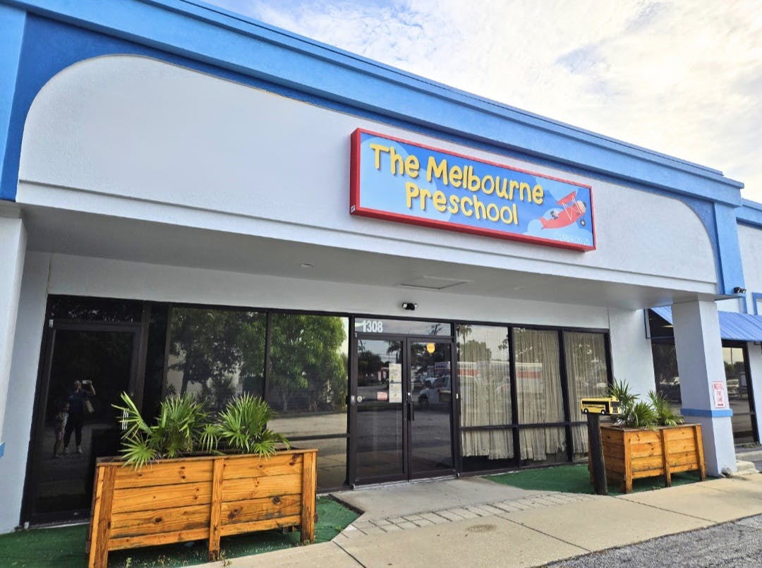 Building exterior with a sign that reads "The Melbourne Preschool"