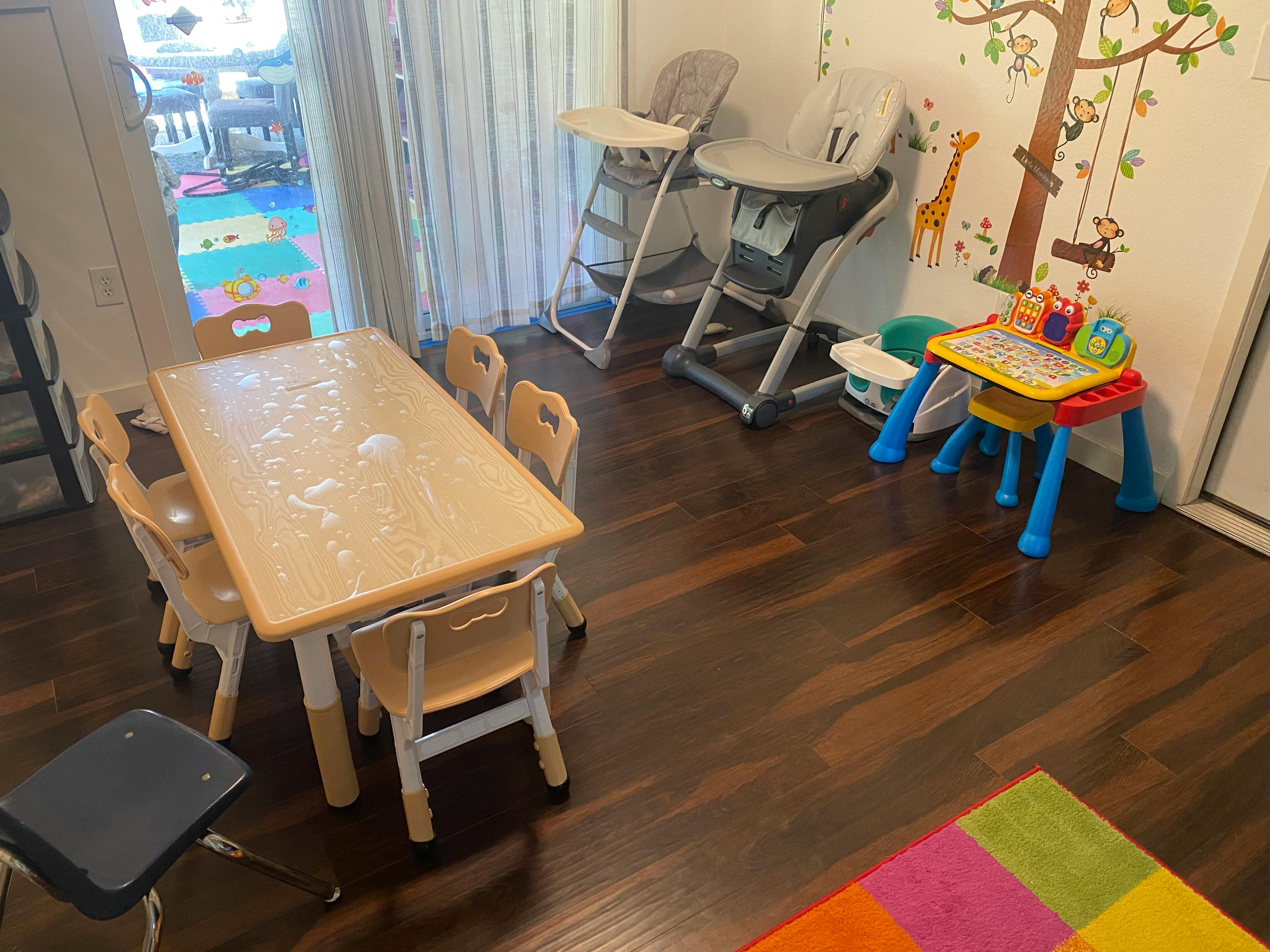 Children's table and chairs with high chairs and activity table in a room