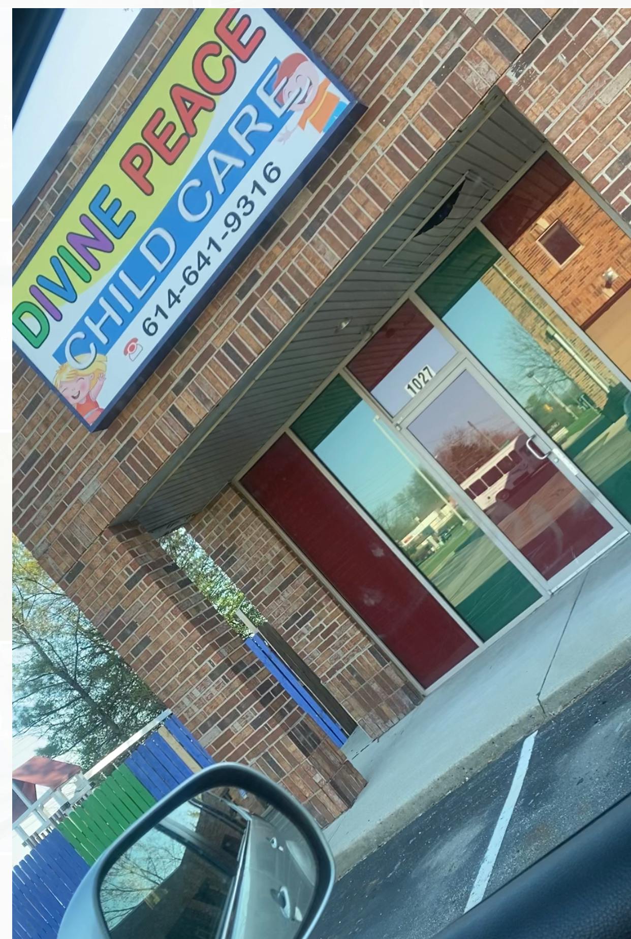 Divine Peace Child Care sign on a brick building
