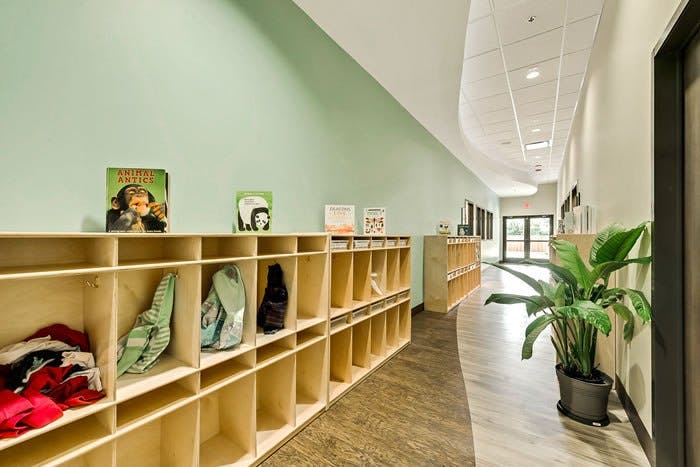 Hallway with cubbies and a plant