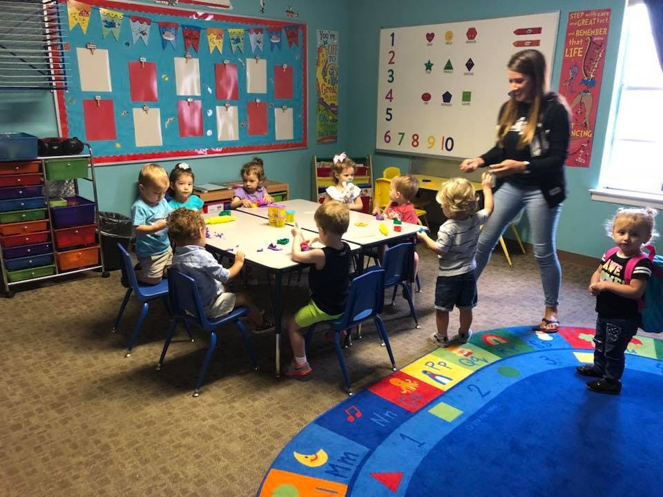 Adult and children in a classroom