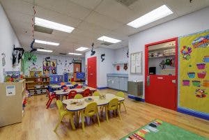 Empty classroom with small tables and chairs