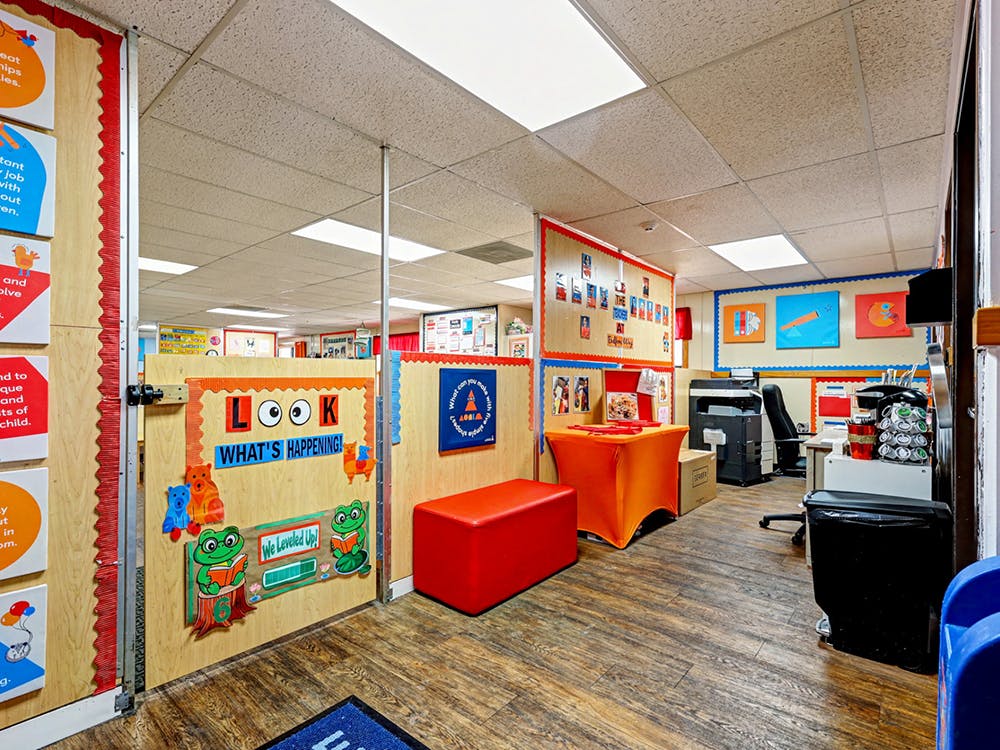 Classroom interior with a bulletin board that says "Look What's Happening!"