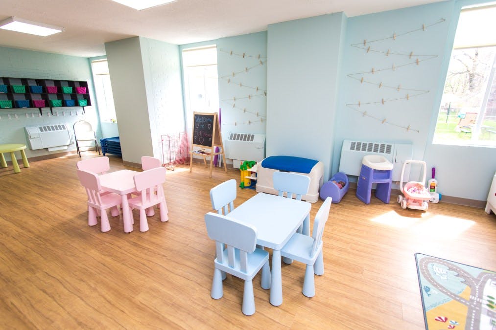 Playroom with small pink and blue tables and chairs