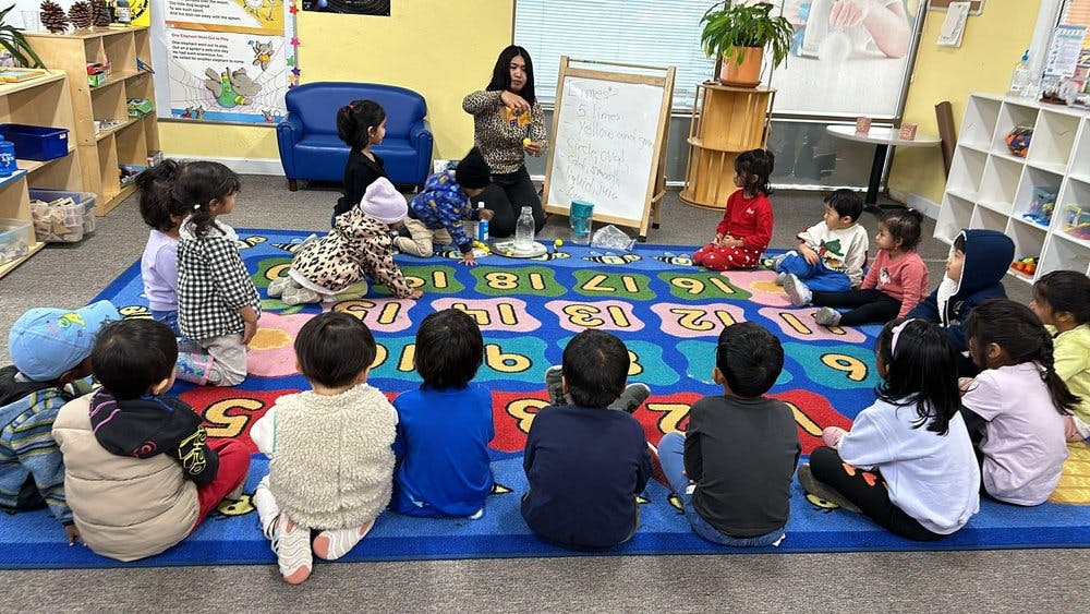 A person teaching children in a classroom setting
