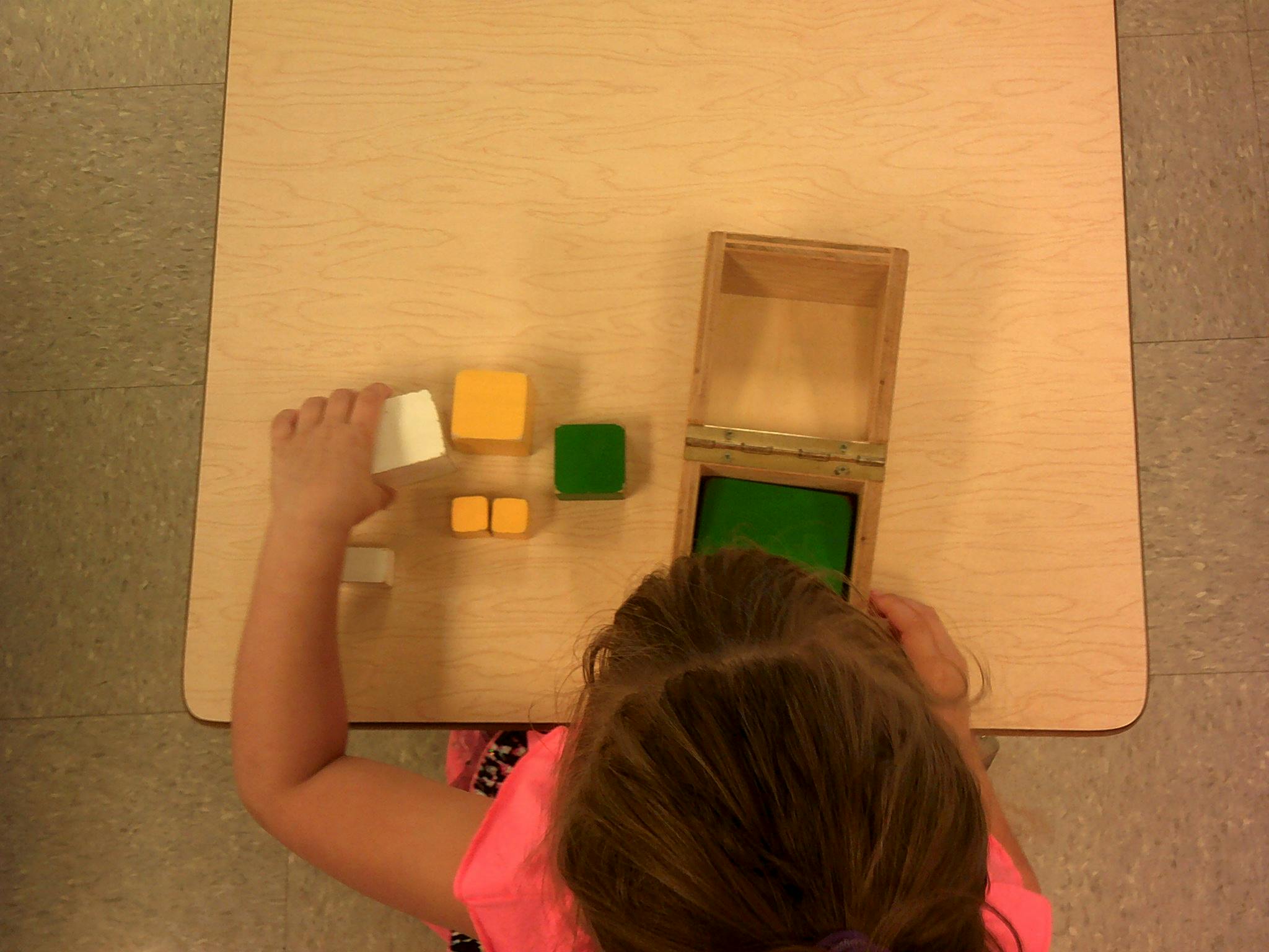 Child playing with colorful blocks on a table