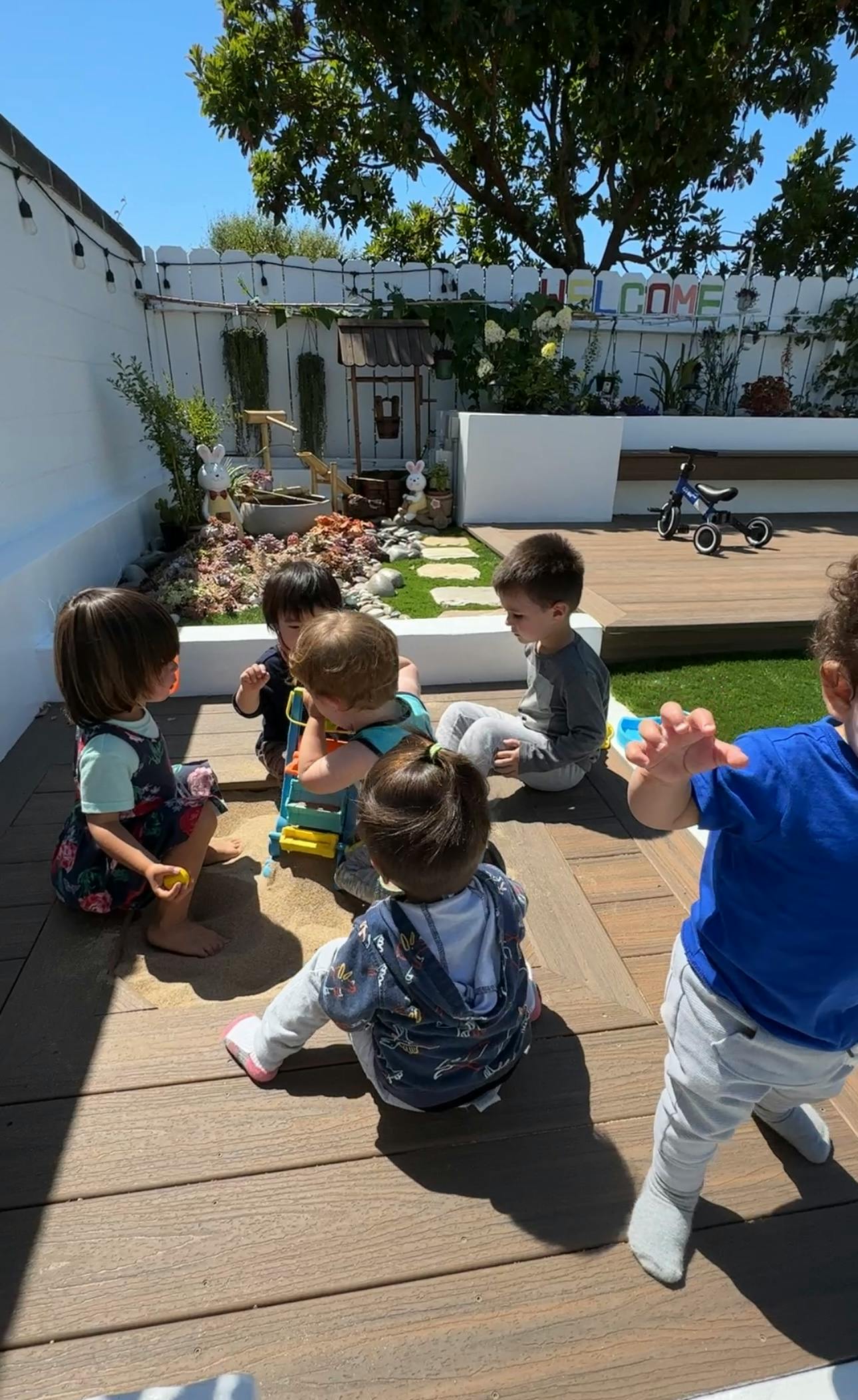 Children playing together on a wooden deck