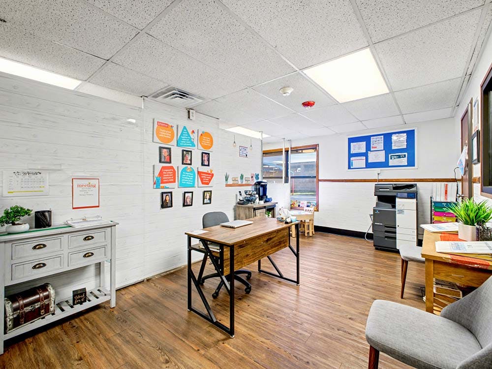 Office space with desks, chairs, and decor on walls