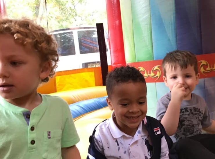Three children in an inflatable bounce house