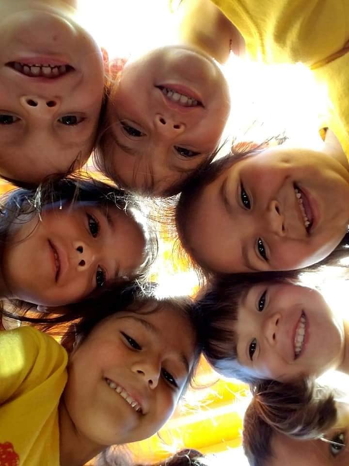 Group of children looking down into the camera