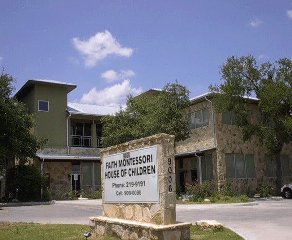Faith Montessori House of Children sign in front of a building
