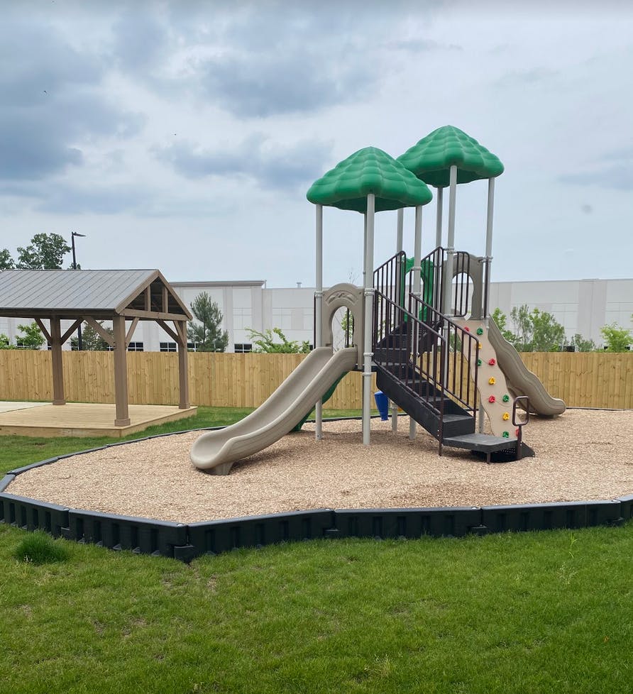 Playground with slides, climbing wall, and covered picnic area