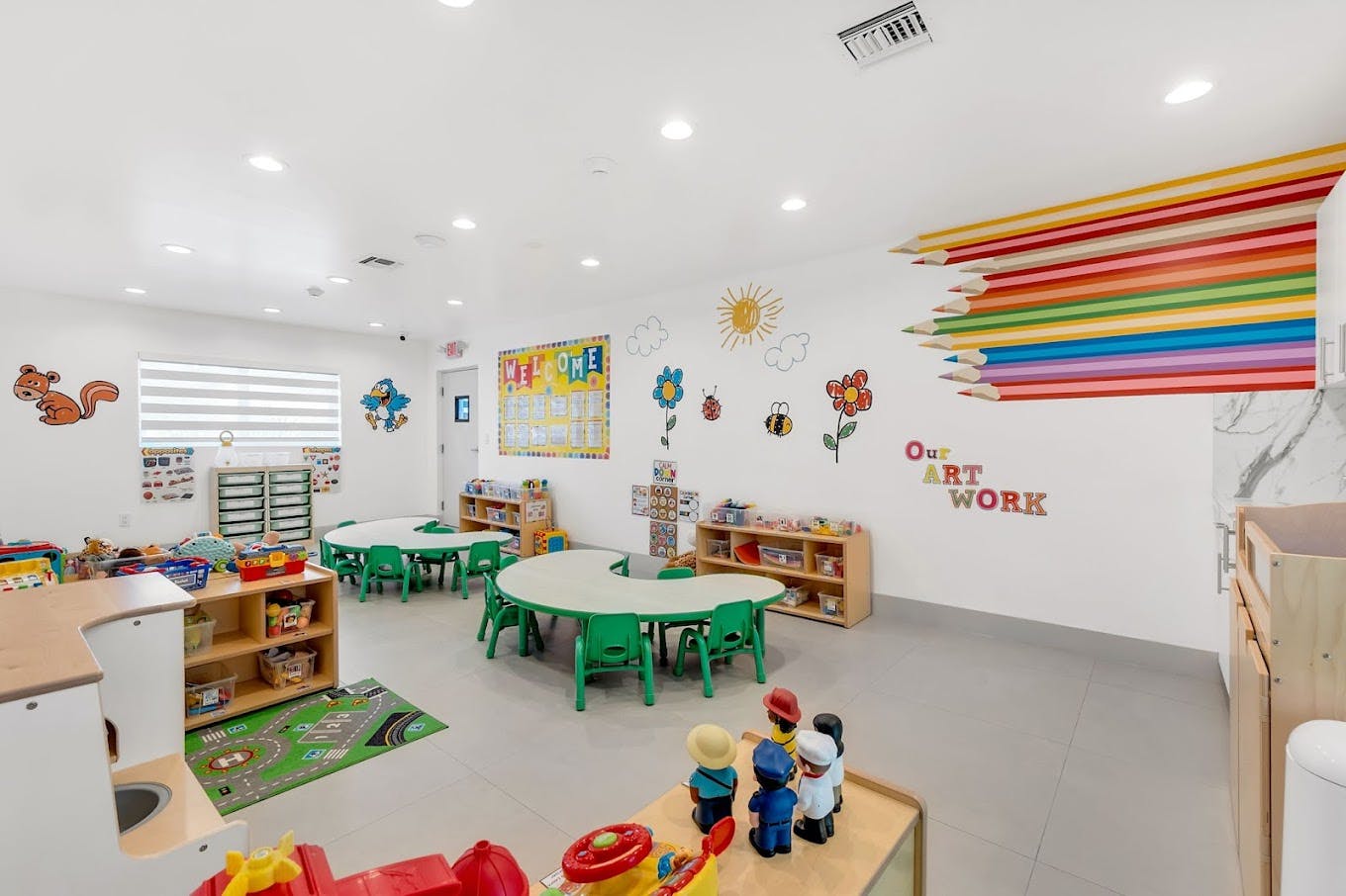 Empty classroom with small tables and chairs, decorated walls