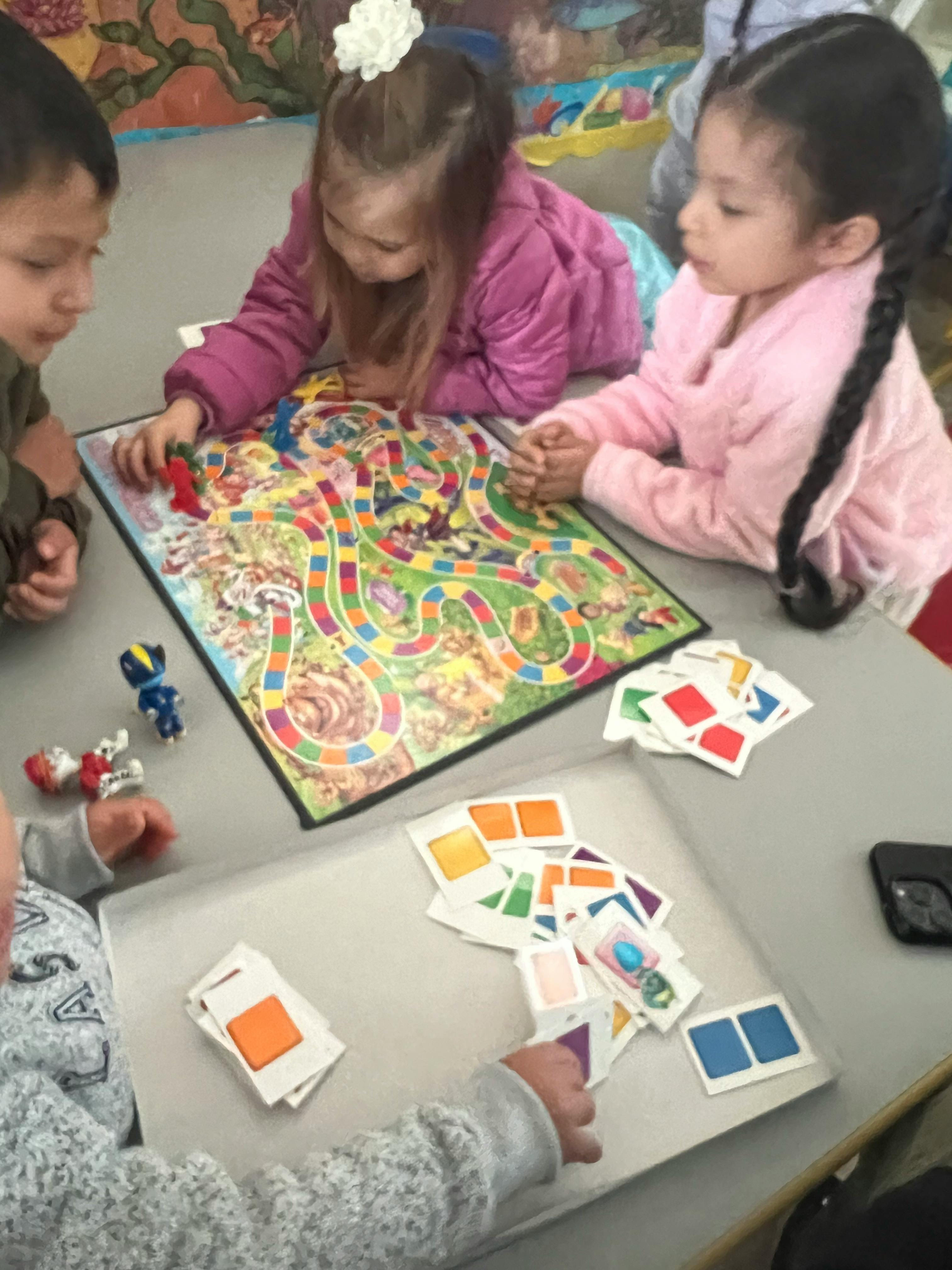 Children playing a board game with cards and cards on a table