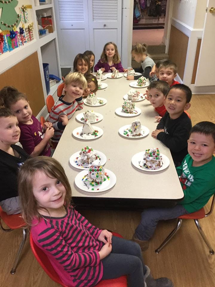 Children sitting at a table with decorated desserts