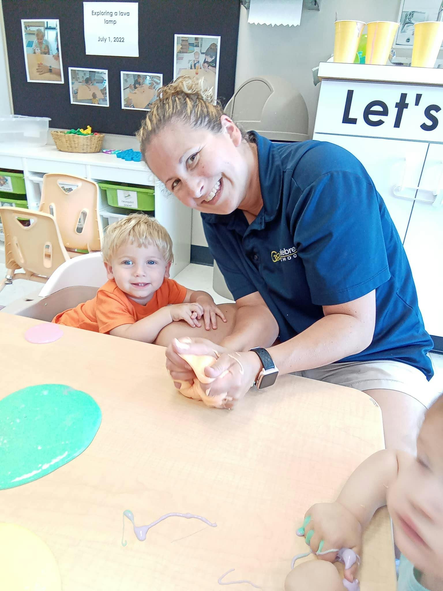Adult and child playing with slime at a table