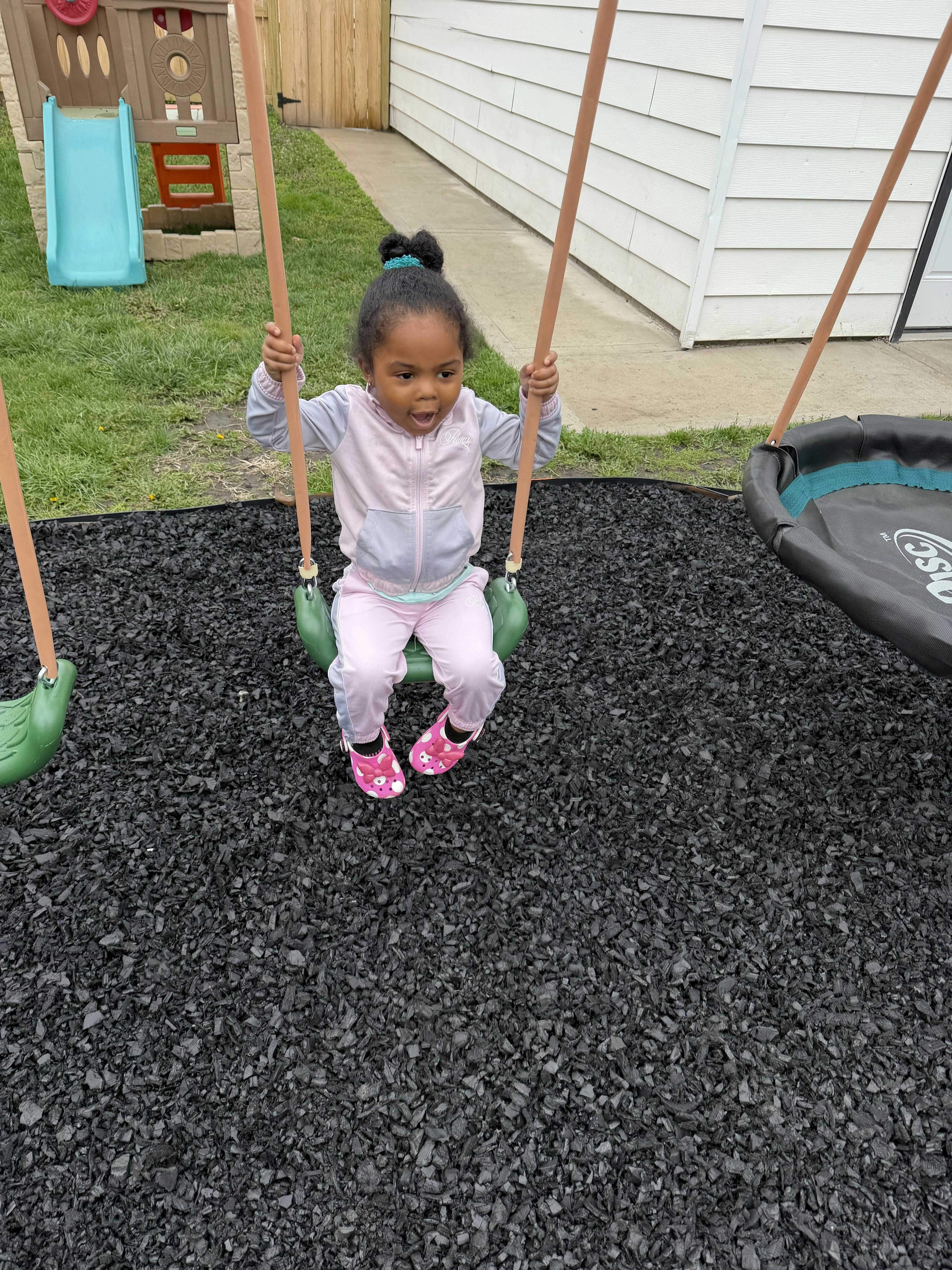 Child sitting on a playground swing