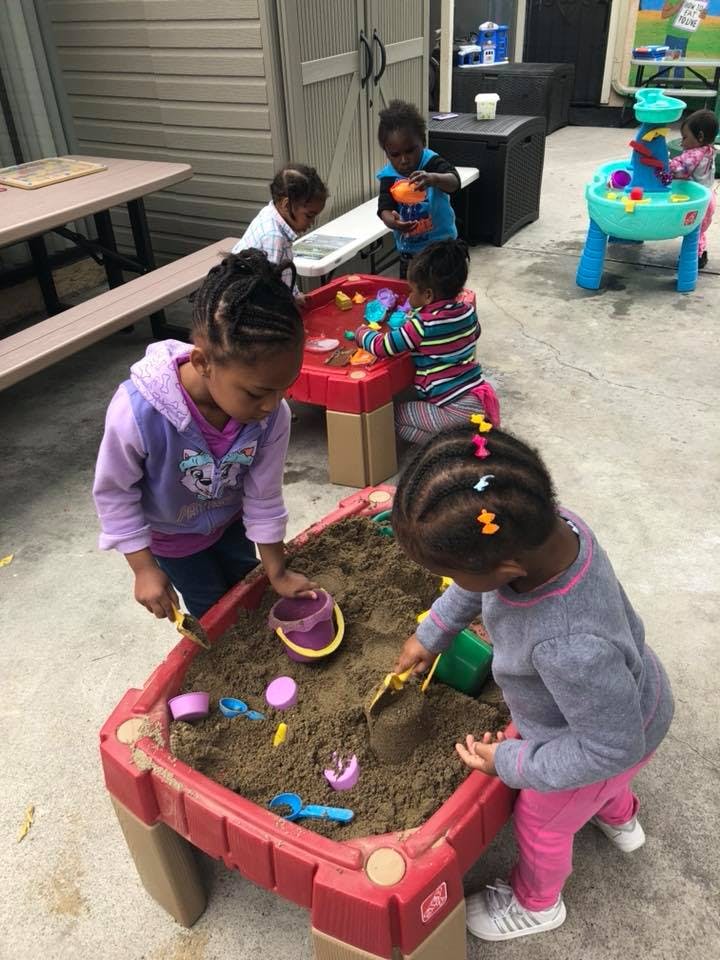 Children playing with sand and water tables