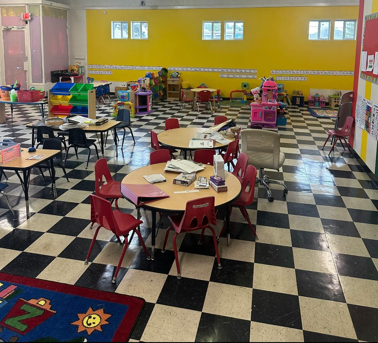 Classroom with tables and chairs on a checkered floor