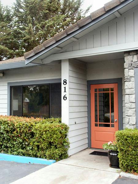 Building exterior with orange door and house number 816