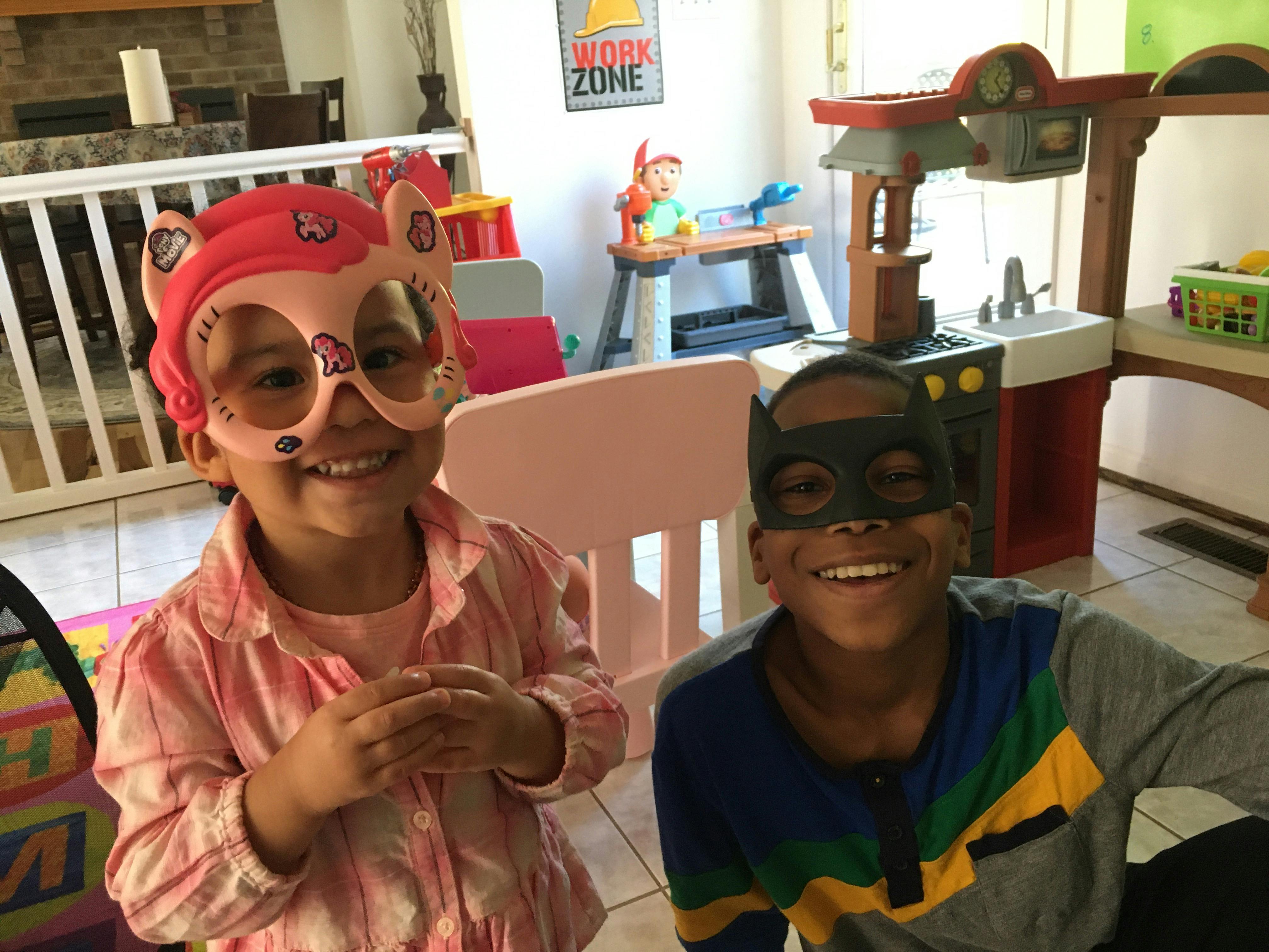 Two children wearing masks