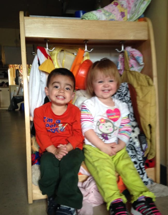 Two children sitting in a cubby