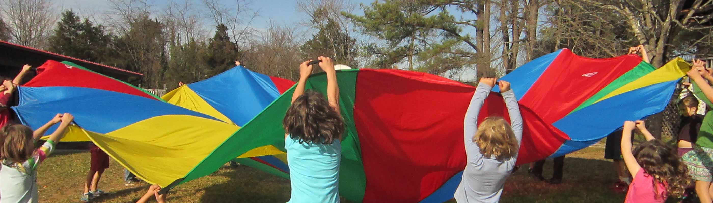 Children holding up a colorful parachute