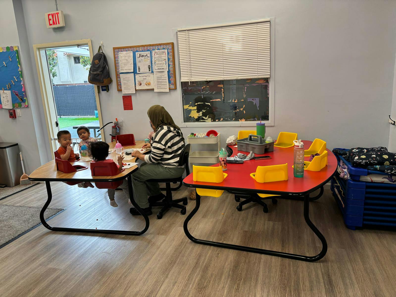 Adult and three children seated at a table