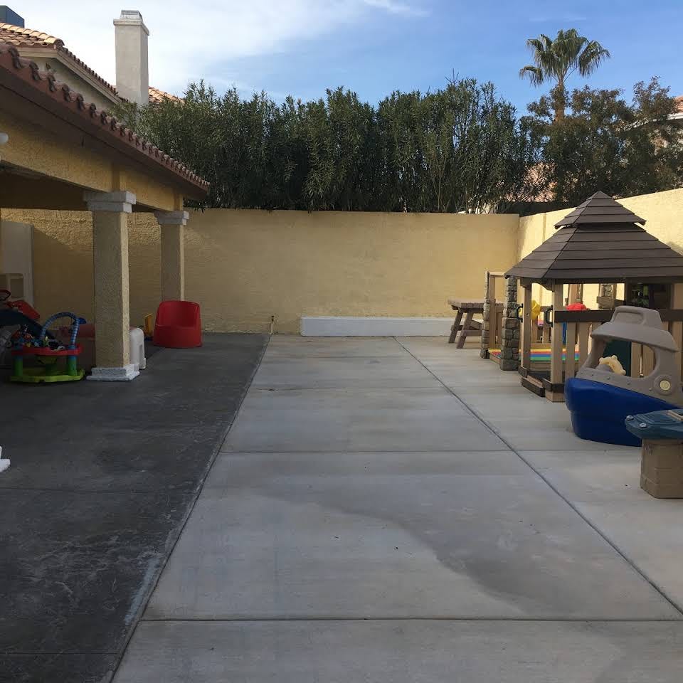 Outdoor patio with a play structure and covered area