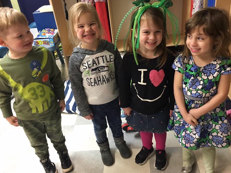 Four children standing together and smiling