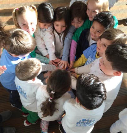 Group of children with hands stacked together